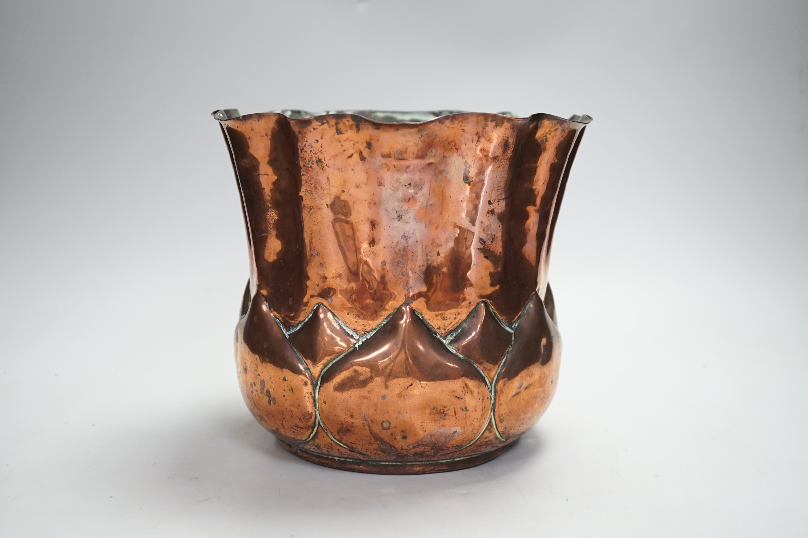 A W.A.S. Benson Arts and Crafts embossed copper jardiniere, impressed mark to the base, 19cm high